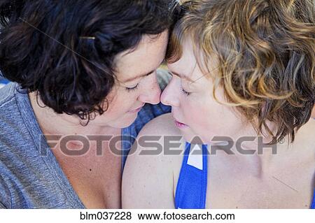 Close up of lesbian couple touching foreheads View Large Photo Image Stock Photo - Close up of lesbian couple touching foreheads. Fotosearch