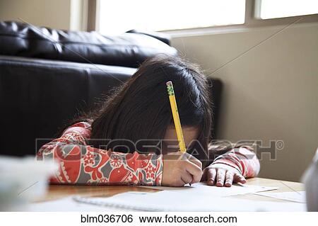 Close up of mixed race girl doing homework View Large Photo Image Stock Photograph - Close up of mixed race girl doing homework. Fotosearch