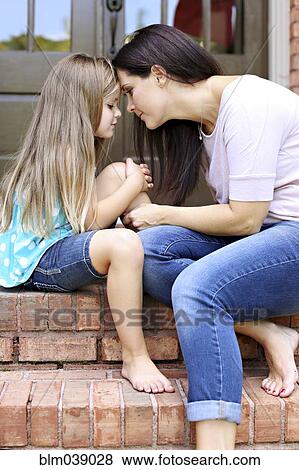 Close up of mother and daughter sitting on front stoop View Large Photo Image Stock Photo - Close up of mother and daughter sitting on front stoop. Fotosearch