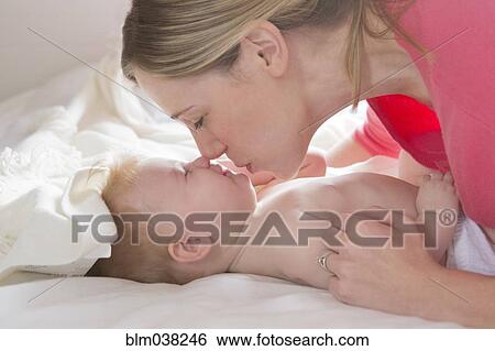 Close up of mother kissing baby girl View Large Photo Image Stock Photograph - Close up of mother kissing baby girl. Fotosearch