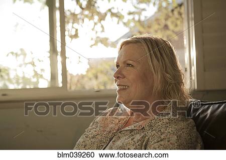 Close up of older woman smiling near window View Large Photo Image Stock Image - Close up of older woman smiling near window. Fotosearch