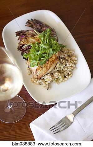 Close up of plate of fish dinner with white wine View Large Photo Image Stock Image - Close up of plate of fish dinner with white wine. Fotosearch