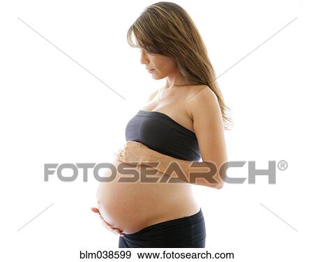 Stock Photo - Close up of pregnant Caucasian woman holding belly. Fotosearch