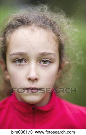 Stock Image - Close up of serious Caucasian girl. Fotosearch