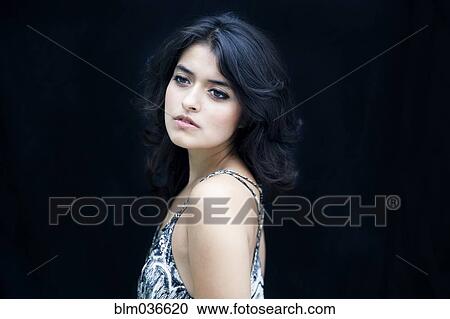 Stock Image - Close up of serious mixed race woman. Fotosearch