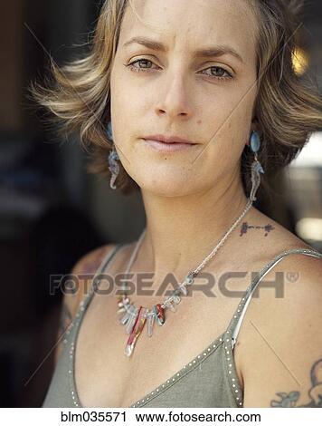 Close up of serious woman wearing jewelry View Large Photo Image Stock Image - Close up of serious woman wearing jewelry. Fotosearch