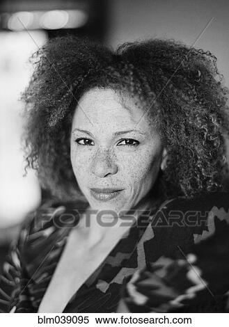 Stock Photography - Close up of serious woman with curly hair. Fotosearch