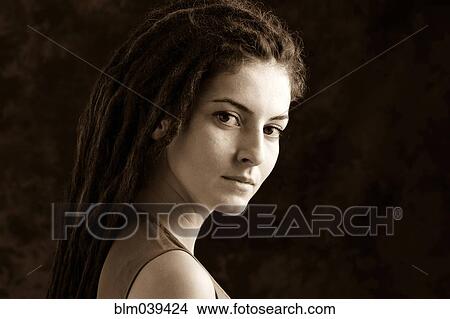 Picture - Close up of serious woman with dreadlocks. Fotosearch