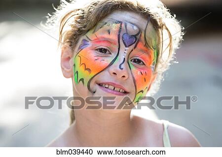Stock Image - Close up of smiling Caucasian girl with face paint. Fotosearch