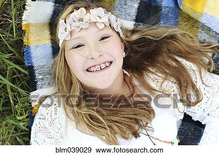 Close up of smiling Caucasian girl with flower crown and braces View Large Photo Image Stock Photo - Close up of smiling Caucasian girl with flower crown and braces. Fotosearch