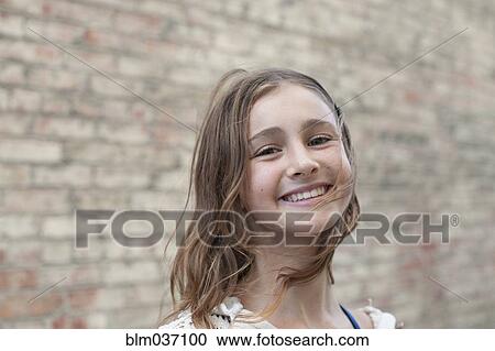 Stock Image - Close up of smiling girl. Fotosearch