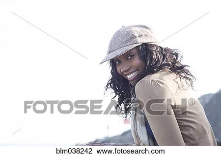 Close up of smiling woman wearing cap outdoors View Large Photo Image Stock Image - Close up of smiling woman wearing cap outdoors. Fotosearch