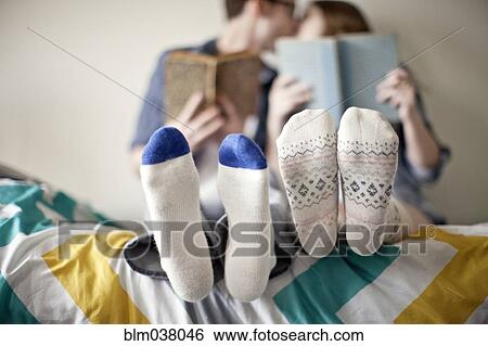 Close up of socks of couple in bed View Large Photo Image Stock Photograph - Close up of socks of couple in bed. Fotosearch