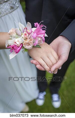 Close up of teenage couple holding hands in prom attire View Large Photo Image Stock Image - Close up of teenage couple holding hands in prom attire. Fotosearch