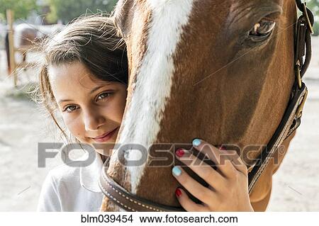 Close up of teenage girl hugging horse View Large Photo Image Picture - Close up of teenage girl hugging horse. Fotosearch