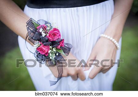 Picture - Close up of teenage girl in prom attire wearing corsage. Fotosearch