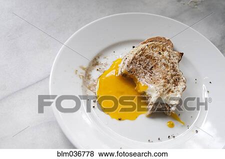 Close up of toast and runny egg yolk breakfast View Large Photo Image Stock Photo - Close up of toast and runny egg yolk breakfast. Fotosearch