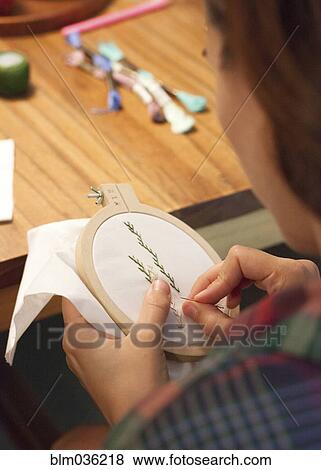 Close up of woman hand-stitching embroidery View Large Photo Image Stock Photo - Close up of woman hand-stitching embroidery. Fotosearch