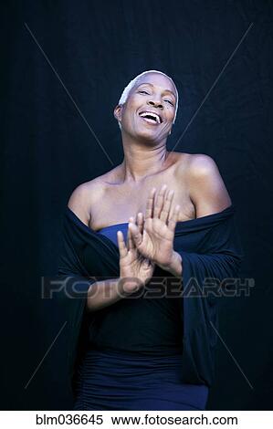 Stock Photography - Close up of woman laughing in shawl. Fotosearch