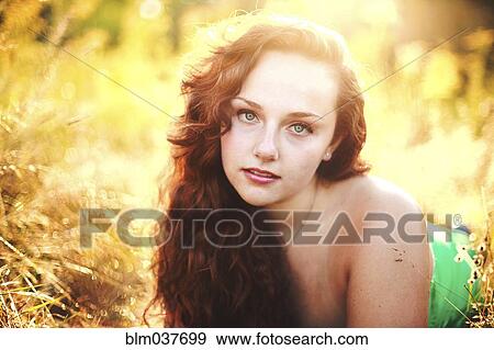Close up of woman laying in tall grass View Large Photo Image Stock Photo - Close up of woman laying in tall grass. Fotosearch