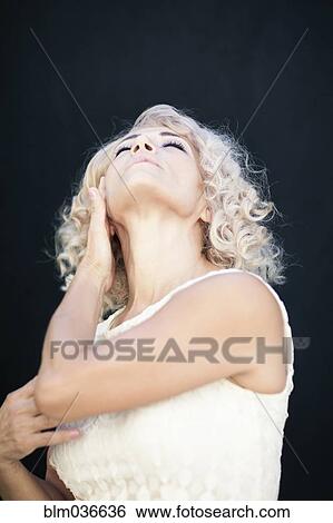 Stock Photograph - Close up of woman looking up. Fotosearch