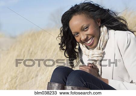 Stock Image - Close up of woman smiling on beach. Fotosearch