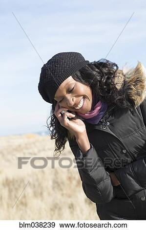 Stock Photo - Close up of woman talking on cell phone outdoors. Fotosearch