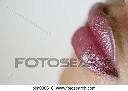 Close up of woman wearing lip gloss View Large Photo Image Stock Photo - Close up of woman wearing lip gloss. Fotosearch