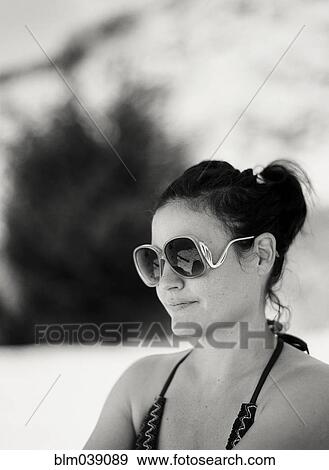 Stock Photo - Close up of woman wearing sunglasses outdoors. Fotosearch