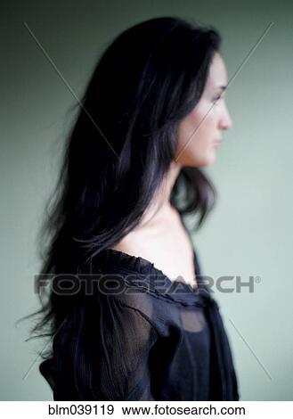 Stock Photo - Close up of woman with long hair and lace blouse. Fotosearch