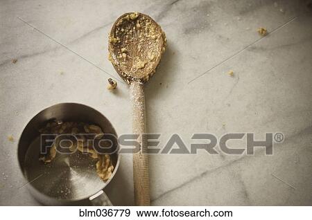 Close up of wooden spoon and measuring cup View Large Photo Image Stock Photo - Close up of wooden spoon and measuring cup. Fotosearch