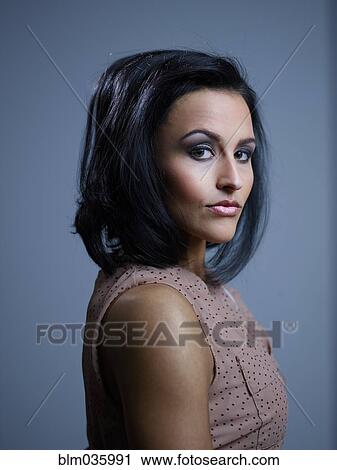 Stock Image - Close up profile of serious Hispanic woman. Fotosearch