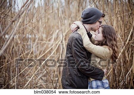 Couple hugging in branches View Large Photo Image Picture - Couple hugging in branches. Fotosearch