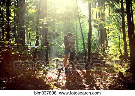Couple hugging in sunny forest View Large Photo Image Stock Photo - Couple hugging in sunny forest. Fotosearch