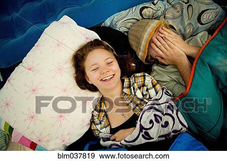 Stock Photo - Couple laughing in camping tent. Fotosearch