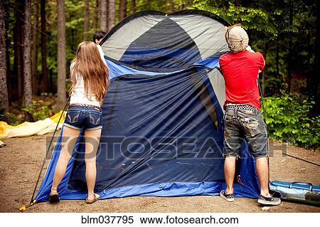 Couple setting up tent at campsite View Large Photo Image Stock Photography - Couple setting up tent at campsite. Fotosearch