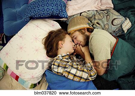 Stock Image - Couple sleeping in camping tent. Fotosearch