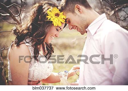 Stock Photo - Couple touching foreheads in park. Fotosearch