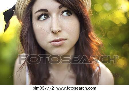 Curious Caucasian woman wearing hat outdoors View Large Photo Image Stock Image - Curious Caucasian woman wearing hat outdoors. Fotosearch