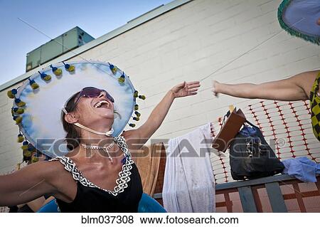Dancing woman wearing sombrero outdoors View Large Photo Image Stock Photo - Dancing woman wearing sombrero outdoors. Fotosearch