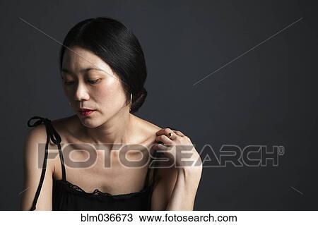 Disappointed Asian woman looking down View Large Photo Image Stock Image - Disappointed Asian woman looking down. Fotosearch