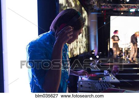 DJ playing music in nightclub View Large Photo Image Stock Photo - DJ playing music in nightclub. Fotosearch