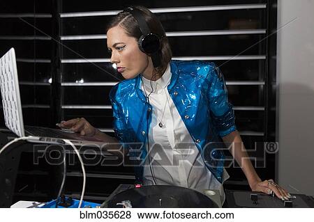 DJ playing music in nightclub View Large Photo Image Stock Photo - DJ playing music in nightclub. Fotosearch