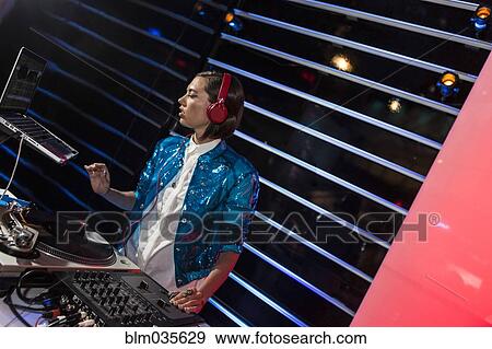 Stock Photo - DJ playing music in nightclub. Fotosearch
