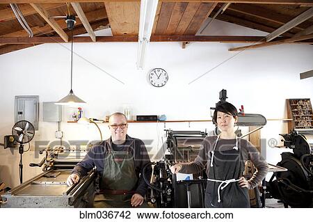 Entrepreneurs smiling in print shop View Large Photo Image Stock Image - Entrepreneurs smiling in print shop. Fotosearch