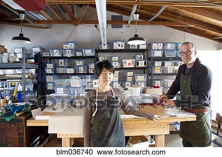 Stock Image - Entrepreneurs working in workshop. Fotosearch