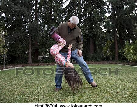 Father and daughter playing in backyard View Large Photo Image Picture - Father and daughter playing in backyard. Fotosearch