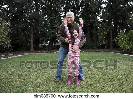 Father and daughter playing in backyard View Large Photo Image Stock Image - Father and daughter playing in backyard. Fotosearch