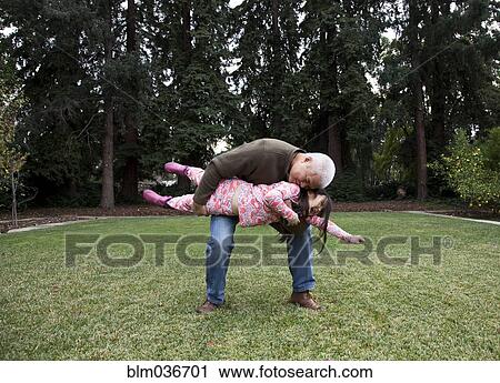 Father and daughter playing in backyard View Large Photo Image Stock Image - Father and daughter playing in backyard. Fotosearch