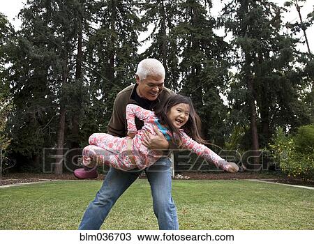 Father and daughter playing in backyard View Large Photo Image Stock Image - Father and daughter playing in backyard. Fotosearch